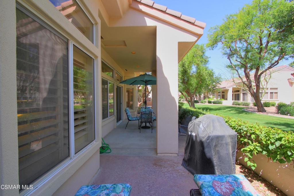 78448 Desert Willow Drive Palm Desert, CA 92211 - Photo 32 of 38 a backyard of a house with outdoor seating and green space
