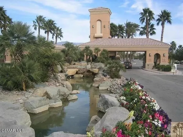 a front view of a house with a yard and mountain view