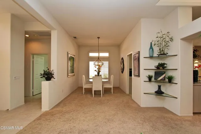 wooden floor in kitchen and an empty room