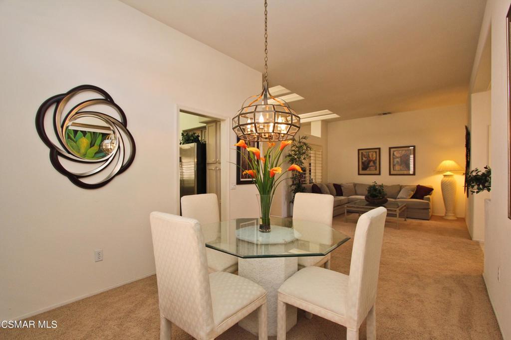 78448 Desert Willow Drive Palm Desert, CA 92211 - Photo 10 of 38 a dining room with furniture and a chandelier