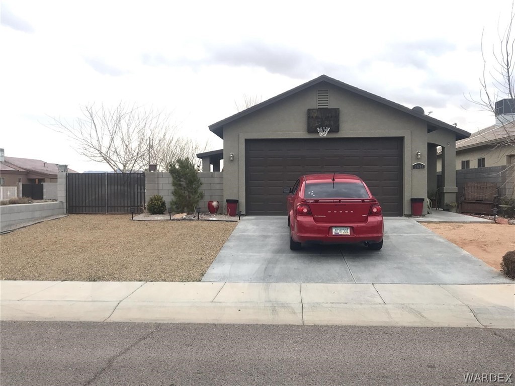 3684 North Kenneth Road Kingman, AZ 86409 - Photo 1 of 1 a car parked in front of a house
