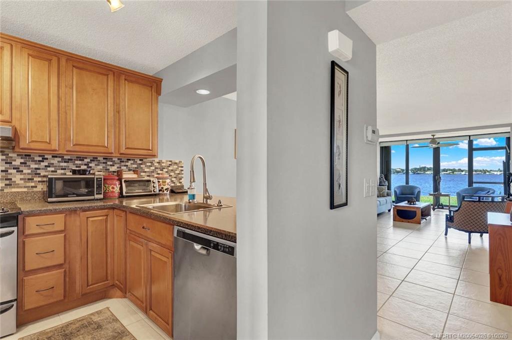 1950 Southwest Palm City Road, Unit 8106 Stuart, FL 34994 - Photo 7 of 54 a kitchen with a sink and cabinets