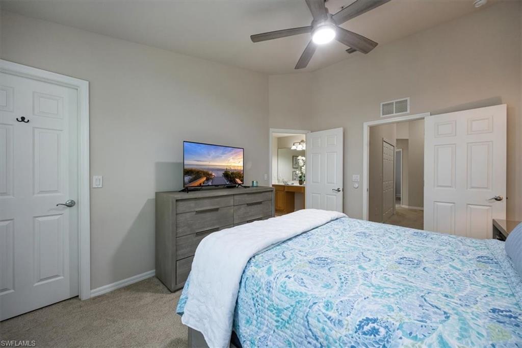 15809 Marcello Circle Naples, FL 34110 - Photo 14 of 33 a bedroom with a bed and a tv