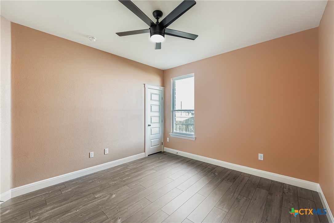 222 Arosa Drive Elgin, TX 78621 - Photo 30 of 40 an empty room with wooden floor and windows