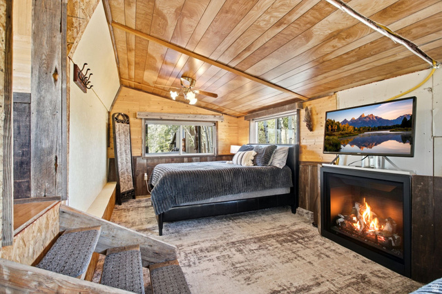1663 Lancer Lane Evanston, UT 82930 - Photo 19 of 101 Wood-paneled ceiling with a central ceiling fan light fixture