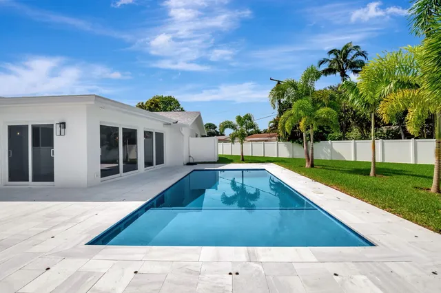 a view of a swimming pool with a lounge chairs