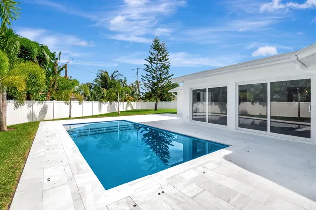a view of a swimming pool with a yard