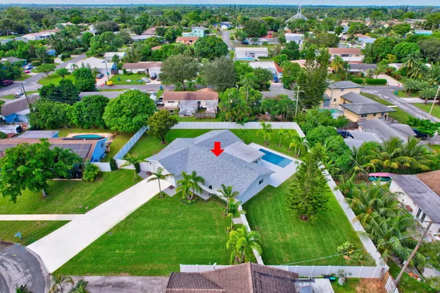 a view of yard with swimming pool and green space