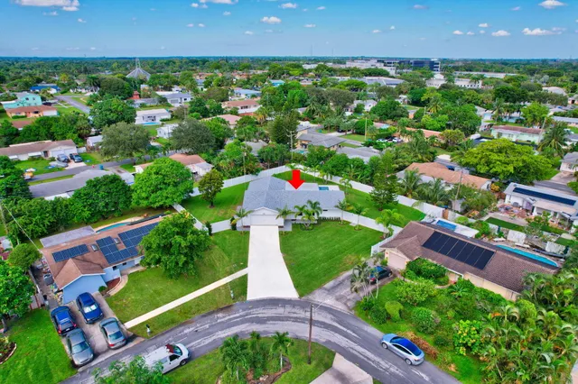 an aerial view of a house with yard swimming pool and outdoor seating