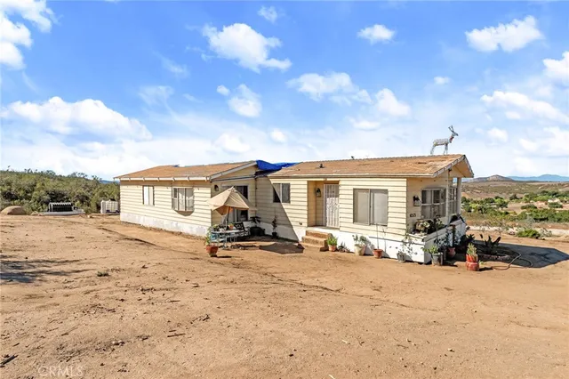 a view of a house with wooden roof and sitting space