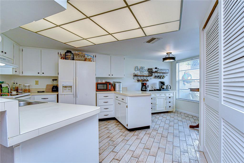 3439 Teeside Drive New Port Richey, FL 34655 - Photo 15 of 85 a kitchen with cabinets and wooden floor