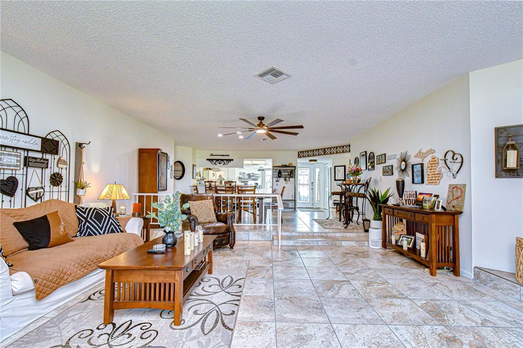 3439 Teeside Drive New Port Richey, FL 34655 - Photo 35 of 85 a living room with furniture a dining table and a fireplace