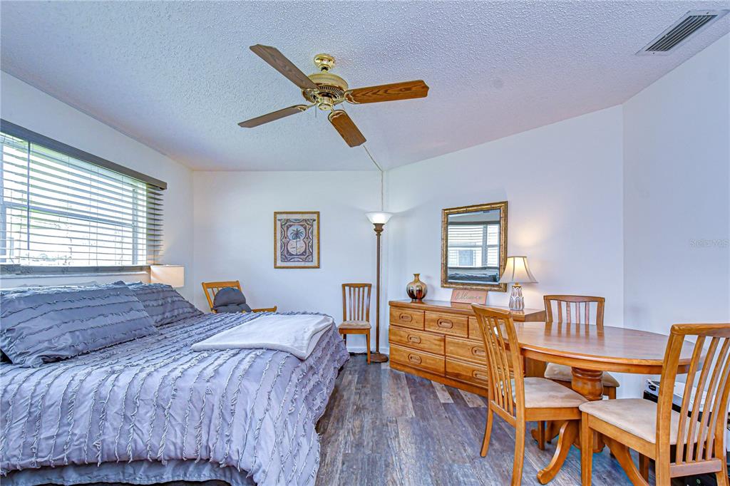 3439 Teeside Drive New Port Richey, FL 34655 - Photo 46 of 85 a bedroom with a bed and wooden floor