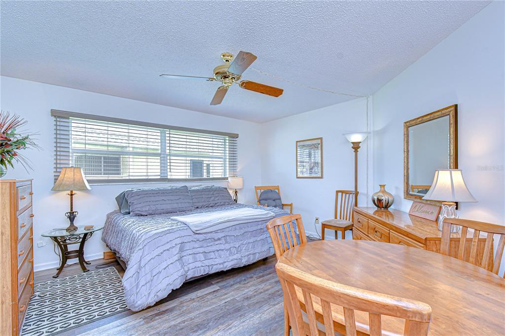 3439 Teeside Drive New Port Richey, FL 34655 - Photo 47 of 85 a bedroom with a bed a chandelier and dresser