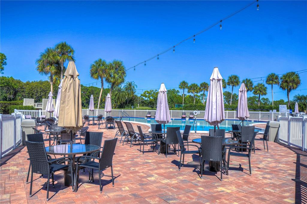 3439 Teeside Drive New Port Richey, FL 34655 - Photo 63 of 85 a view of a patio with a dining table and chairs with plants
