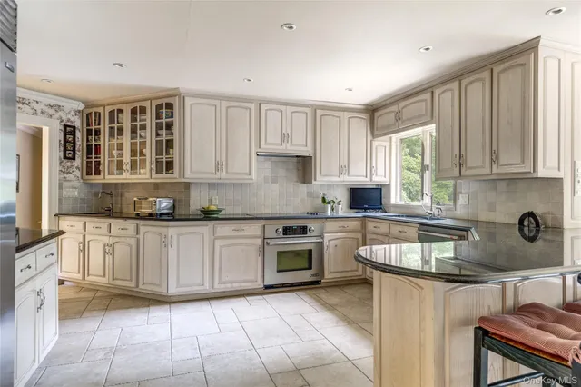 a kitchen with a stove sink and cabinets
