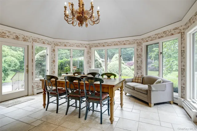 a living room with furniture and floor to ceiling windows