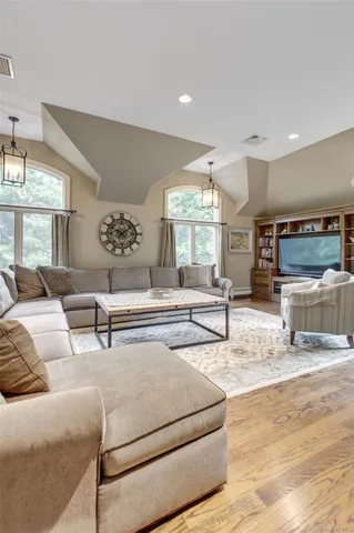 a living room with furniture and a chandelier