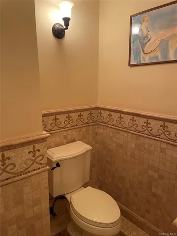 a white toilet sitting next to a shower