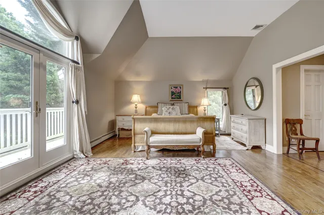 a bedroom with furniture and a large window