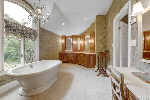 a large spacious bathroom with a tub and shower
