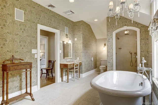 a spacious bathroom with a bathtub and shower