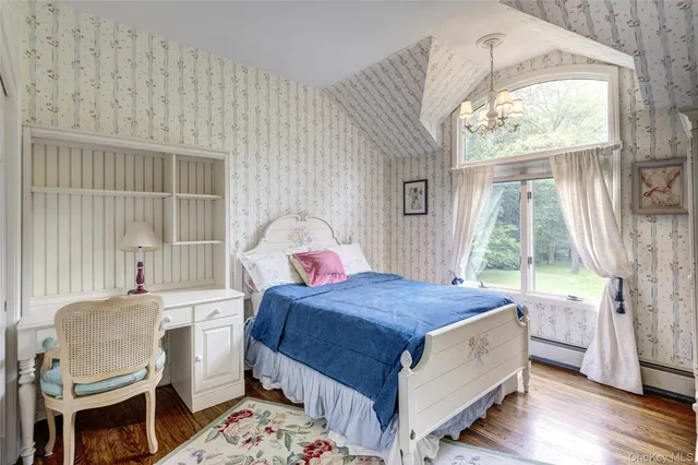 a bedroom with a bed chair and window