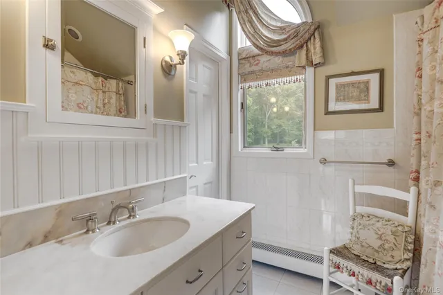 a bathroom with a sink a mirror and a shower