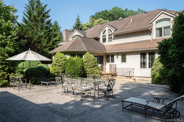 a view of house with backyard outdoor seating and green space