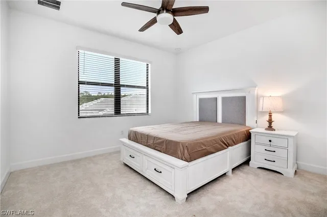 a spacious bedroom with a bed and window