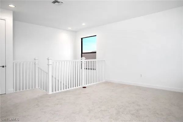a view of a livingroom with a white wall and a window