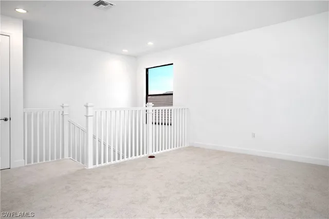 a view of a livingroom with a white wall and a window