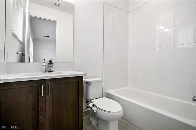 a bathroom with a sink a toilet and bathtub