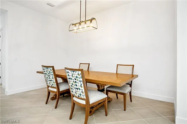 a dining room with furniture and chandelier