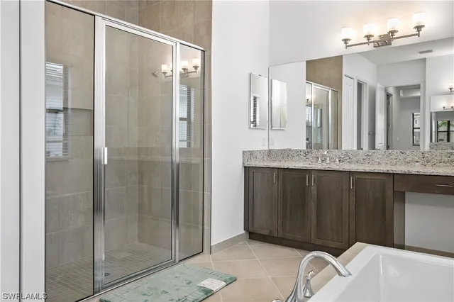 a bathroom with a granite countertop sink mirror and shower