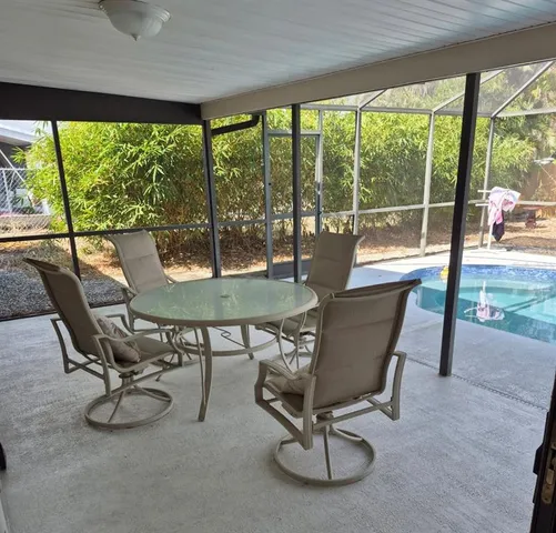 a view of a patio with table and chairs