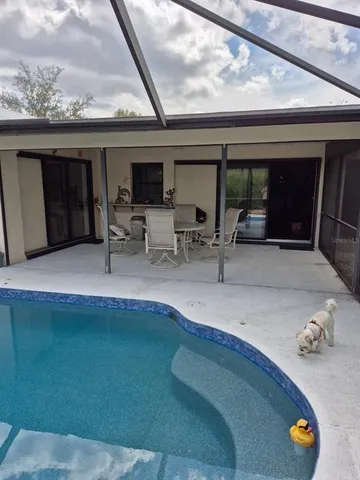 a backyard of a house with table and chairs