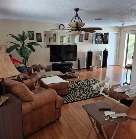 a living room with furniture fireplace and flat screen tv