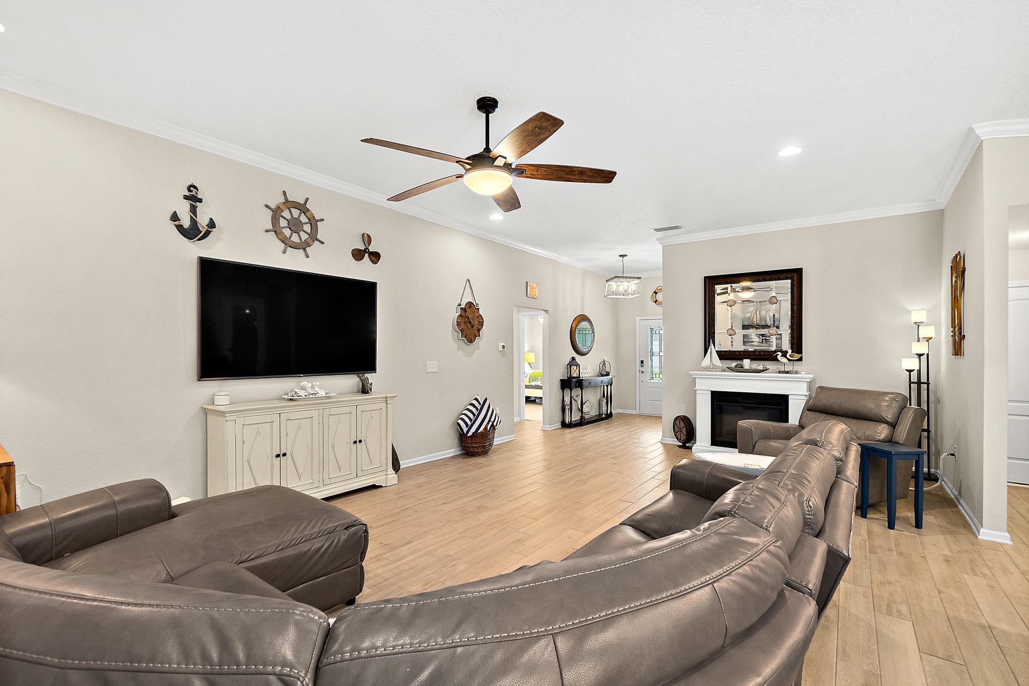 602 Crescent Key Drive St. Augustine, FL 32086 - Photo 22 of 47 a living room with furniture and a flat screen tv