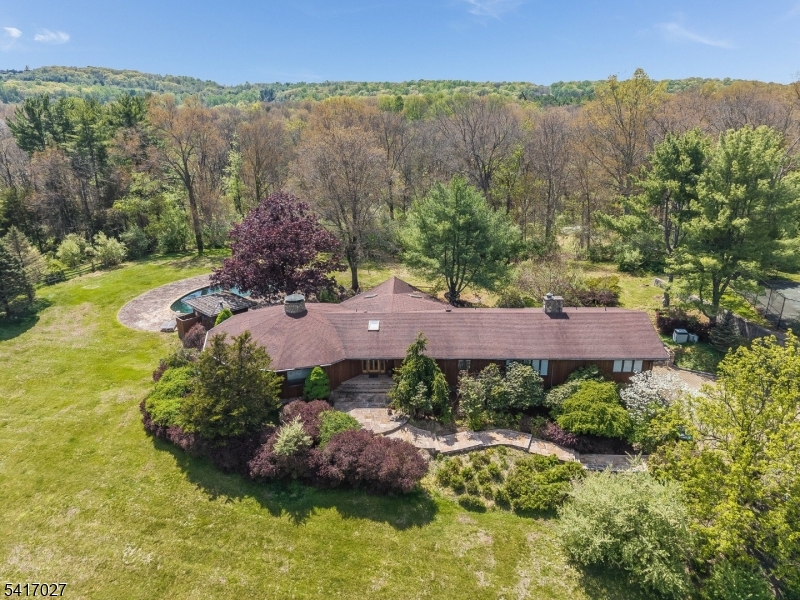 166 River Road Annandale, NJ 08801 - Photo 1 of 37 an aerial view of a house with a garden and mountains