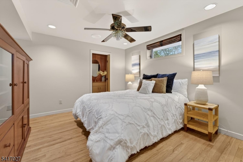 166 River Road Annandale, NJ 08801 - Photo 37 of 37 a bedroom with a bed and a chandelier