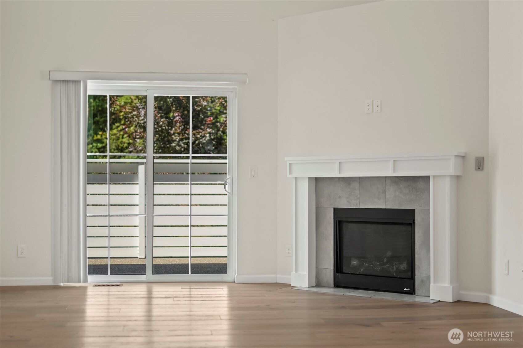 1080 East Old Ranch Road, Unit A1A2 Allyn, WA 98524 - Photo 31 of 35 a view of empty room with wooden floor and a fireplace