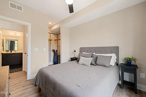 a bedroom with a bed and wooden floor