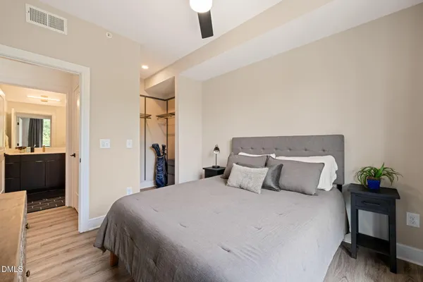 a bedroom with a bed and wooden floor
