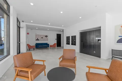 a living room with furniture and a glass door