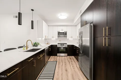 a kitchen with a refrigerator and a sink