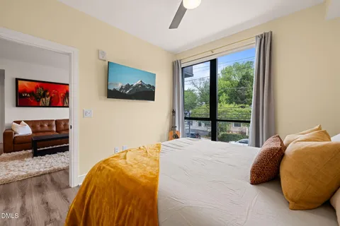 a bedroom with a bed and a large window