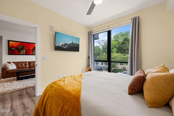 a bedroom with a bed and a large window