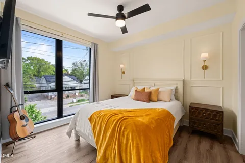 a bedroom with a bed and wooden floor