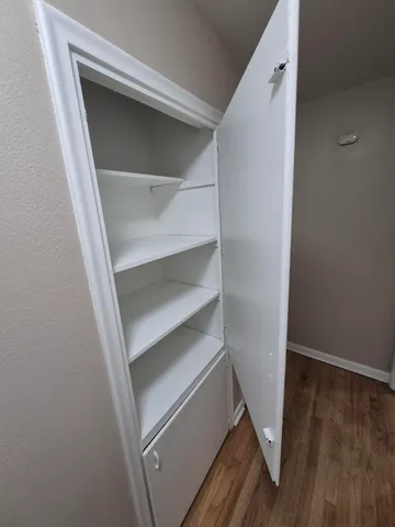 a storage room with wooden floor